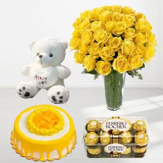 30 yellow roses in glass vase with mango cake with 16 pcs rocher ferrero cake with a cute 1 feet height teddybear 