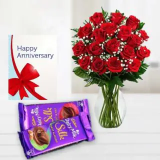 20 red roses arranged in glass vase , set of 2 dairy milk silk chocolates, anniversary greeting card 