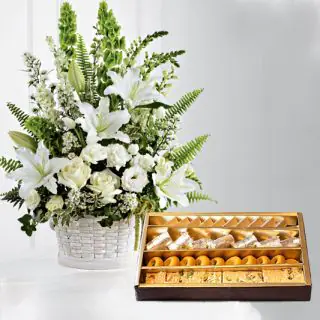 Basket arrangement of white exotic flowers with 1 kg assorted sweets