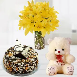 Beautiful vase arrangement of yellow lilies with 1 feet height teddybear with dryfruits cake 