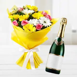Bunch of mix flowers with bottle of champegne
