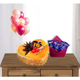  heart shape mango cake with pack of 5 dairy milk chocolates with bunch of 5 blown balloons 