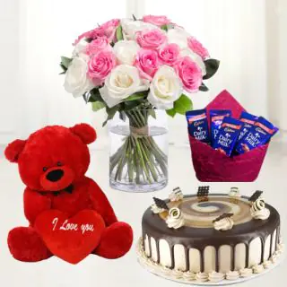 vase arrangement of red and pink roses , 6 inch red teddybear ,irish coffee cake with set of 5 dairy milk chocolates 