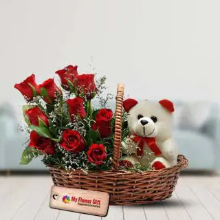 basket arrangement of 15 red roses with a cute teddybear sitting in it 