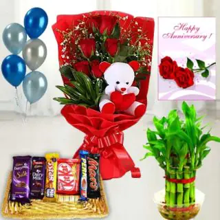 6 red roses bunch with 6 inch teddybear arranged in it, basket of assorted chocolates, 6 inch height teddybear , 2 layer Lucky bamboo plant ,5 blown balloons with anniversary greeting card