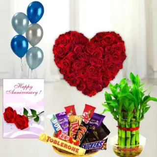 Heart shape arrangement of 40 red roses, basket of assorted chocolates, 6 inch height teddybear , 2 layer Lucky bamboo plant ,5 blown balloons with anniversary greeting card