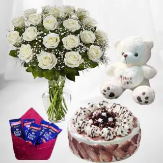 20 white roses in glass vase with irish coffee cake with 1 feet height teddybear with pack of 5 dairy milk chocolates 