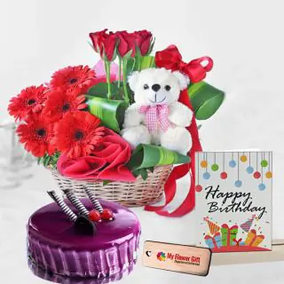 Basket arrangement of red gerberas with teddy bear sitting in it with half kg black currant cake with birthday card 