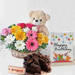 Basket Arrangement of mix colour gerberas with cute teddybear sitting in it with half kg chocolate truffle cake with birthday card 
