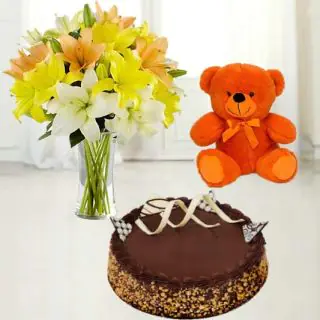 Vase arrangement of 8 white and yellow lilies with 6 inch teddybear with chocolate walnut cake 