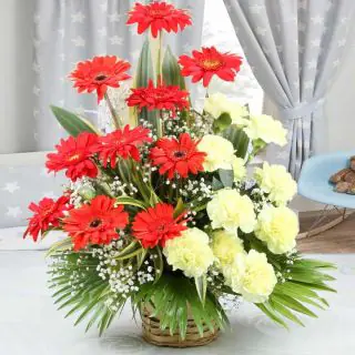 Basket arrangement of 10 yellow carnations with 10 red gerberas 