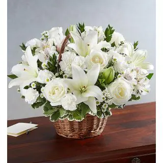 Basket arrangement of white lilies with white roses 