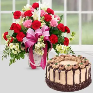 basket of mix flowers with chocolate cake 