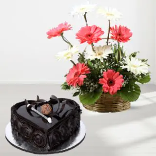 basket of pink and white gerberas with heart shape dark chocolate cake 
