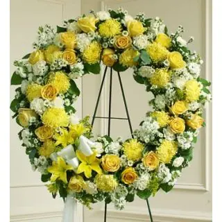 Beautiful wreath of yellow and white mix flowers including roses, carnations, gerberas, daisies 