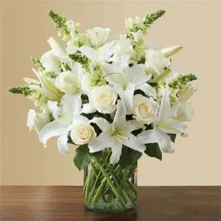 Exclusive elegant looking Vase arrangement of white lilies with white roses 