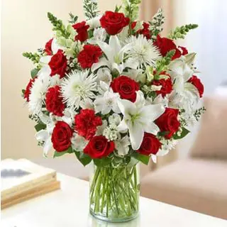 Exclusive vase arrangement of roses, carnations with lilies 