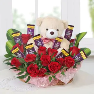 basket of flowers with teddy and chocolate