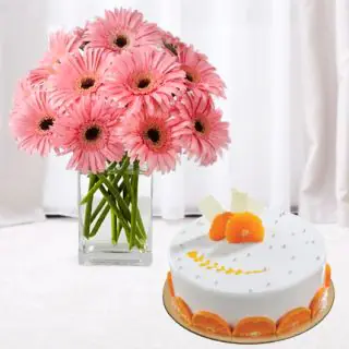 Vase arrangement of 15 pink gerberas with orange cool cake
