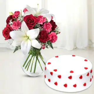 Vase arrangement of lilies, roses and carnations with vanilla cool cake 