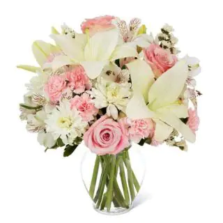 Vase arrangement of pink carnations,pink roses with white lilies 