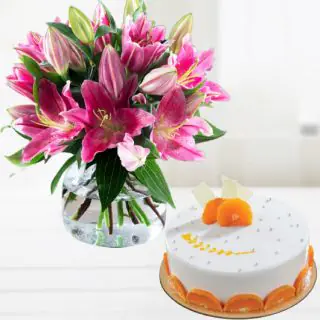 Vase arrangement of pink lilies with orange cool cake 