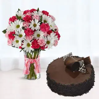 vase arrangement of white daisy with pink roses with chocolate cake