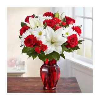 Vase arrangement of white  lilies , red carnations with red roses 