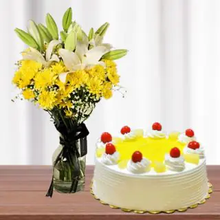 Vase arrangement of white lilies with yellow daisies with half kg pineapple cool cake 