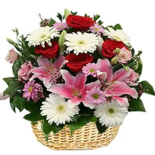 Basket arrangement of exotic mix flowers including roses, lilies, carnations, gerberas daisies