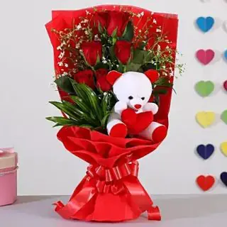 Bunch of 6 red beautiful  roses with 6 inch teddybear arranged  in it