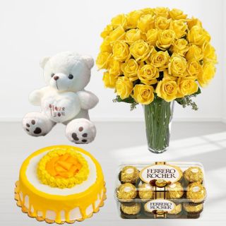 30 yellow roses in glass vase with mango cake with 16 pcs rocher ferrero cake with a cute 1 feet height teddybear 