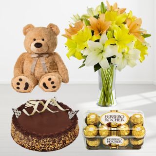 Exotic vase arrangement of 10 yellow and white lilies with 1 feet height brown teddybear, chocolate walnut cake with 16 pcs rocher ferrero chocolates 5500