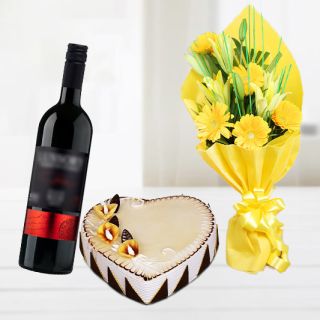 Bunch of gerberas & lilies with heart shape butterscotch cake with bottle of red wine