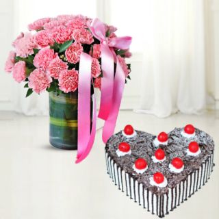 15 pink carnations arranged in glass vase with heart shape black forest cake 