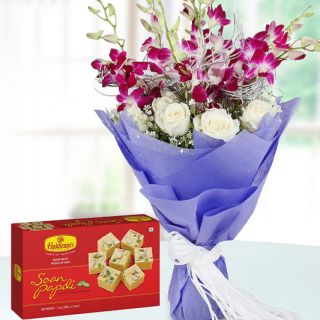 Bunch of lavender orchids with white roses with box of 1 kg soan papdi sweets