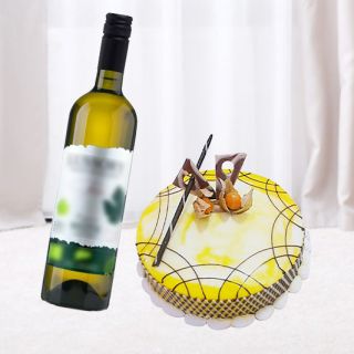 pineapple fresh cream cake with bottle of white wine 