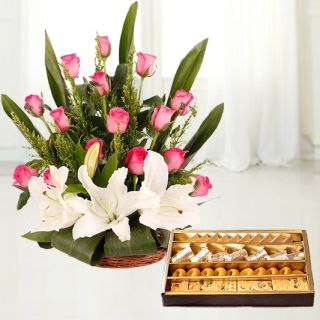 Basket arrangement of white lilies with pink roses with 1 kg assorted sweets