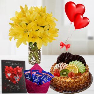 10 Yellow Lilies in glass vase , half kg premium quality buttercotch fruit cake, pack of 5 dairy milk chocolates, 2 heart shape balloons , Greeting card 