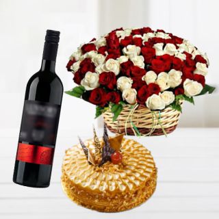 Basket of 50 red and white roses with butterscotch cake with bottle of red wine