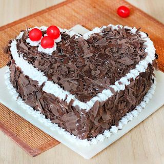 heart shape black forest heart shape cool cake with chocolates flakes topping  