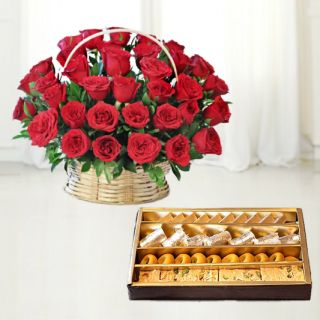 Basket arrangement of 50 red roses with 1 kg assorted sweets