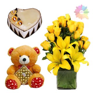 basket arrangement of lilies and roses with heart shape butterscotch cake with 2 feet height teddy bear carrying box of 24 pcs rocher ferrero chocolates
