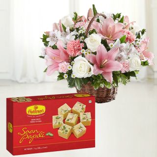 Exotic arrangement of lilies, anthuriums with roses and carnations with 1 kg soan papdi sweets
