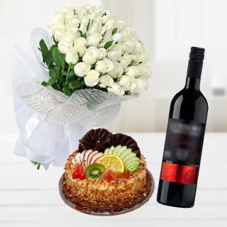 Bunch of 12 white roses with mix fruit premium quality cake with bottle of red wine 