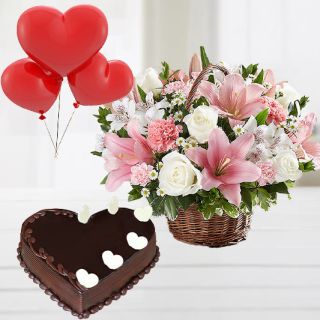Exotic Basket arrangement of lilies&roses arrangement with chocolate truffle heart shape cake with 3 heart shape balloons