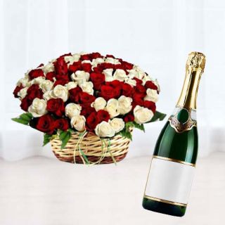 Basket arrangement of 50 red and white roses with bottle of champegne
