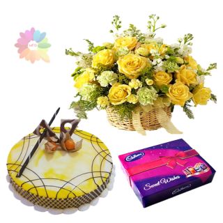Basket of 12 yellow roses with pineapple cake with box of cadburys celebration