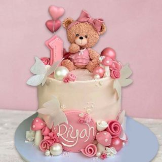 strawberry Designer cake with teddybear sitting on it 