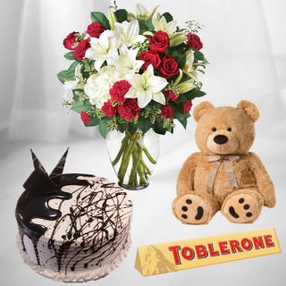 15 Mix flowers in glass vase with choco vanilla cake with toblerone chocolate with 10 inch brown teddybear 